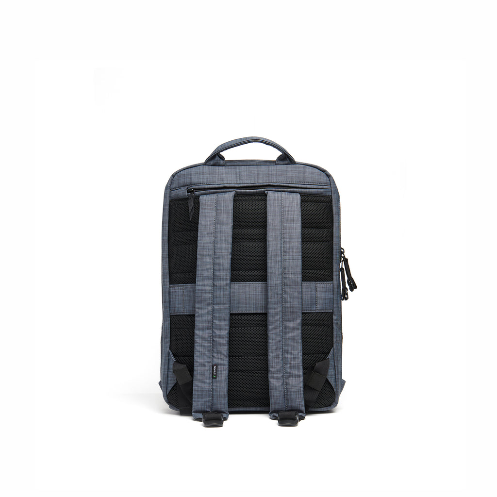 Mueslii small backpack,  made of  water resistant canvas nylon,  with a laptop compartment, color slate grey, back view.