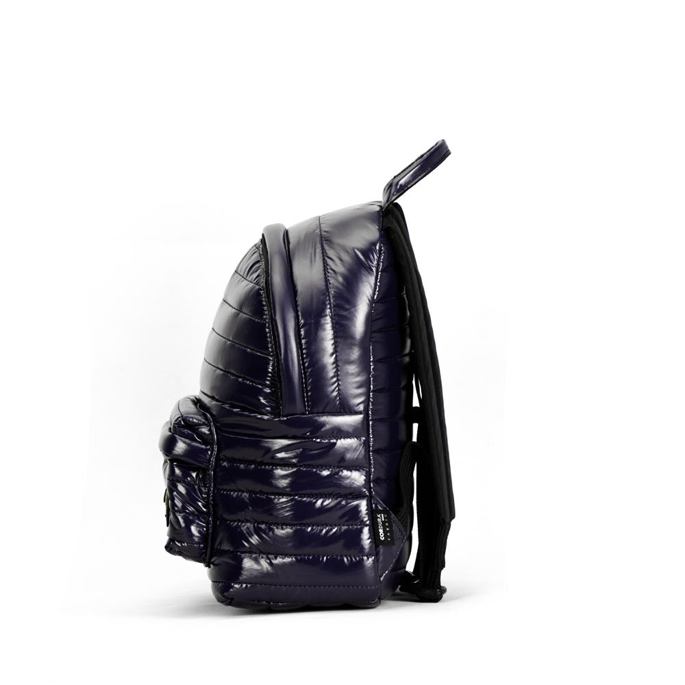 Mueslii original puffer medium and small backpack made of high density nylon and Ykk zips, color blue, side view.